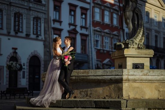 portrait-beautiful-smiling-love-couple-sitting-near-fountain-sunny-day_192420-2056 (1)