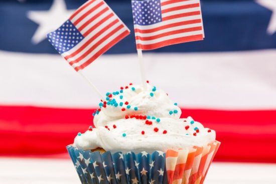 sweet-whipped-cream-cupcake-with-american-flags_23-2148150638