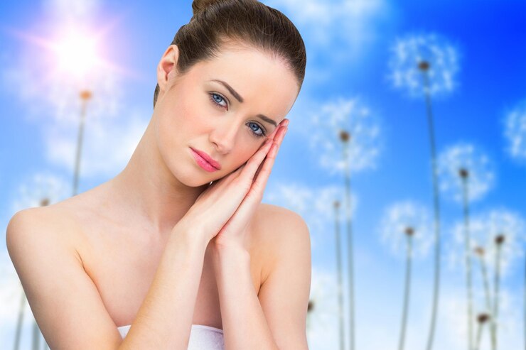 beautiful-brunette-with-hands-face-against-digitally-generated-dandelions-against-blue-sky_1134-50725