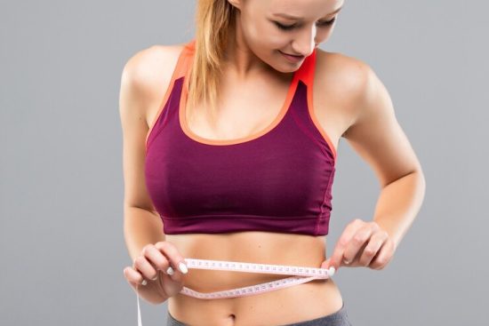 fitness-woman-measuring-her-body-isolated-weight-loss-concepts_231208-10391