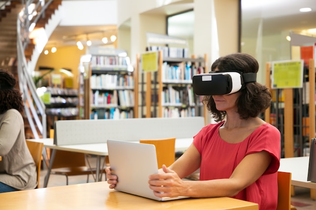 woman-using-vr-simulator-library_74855-1875